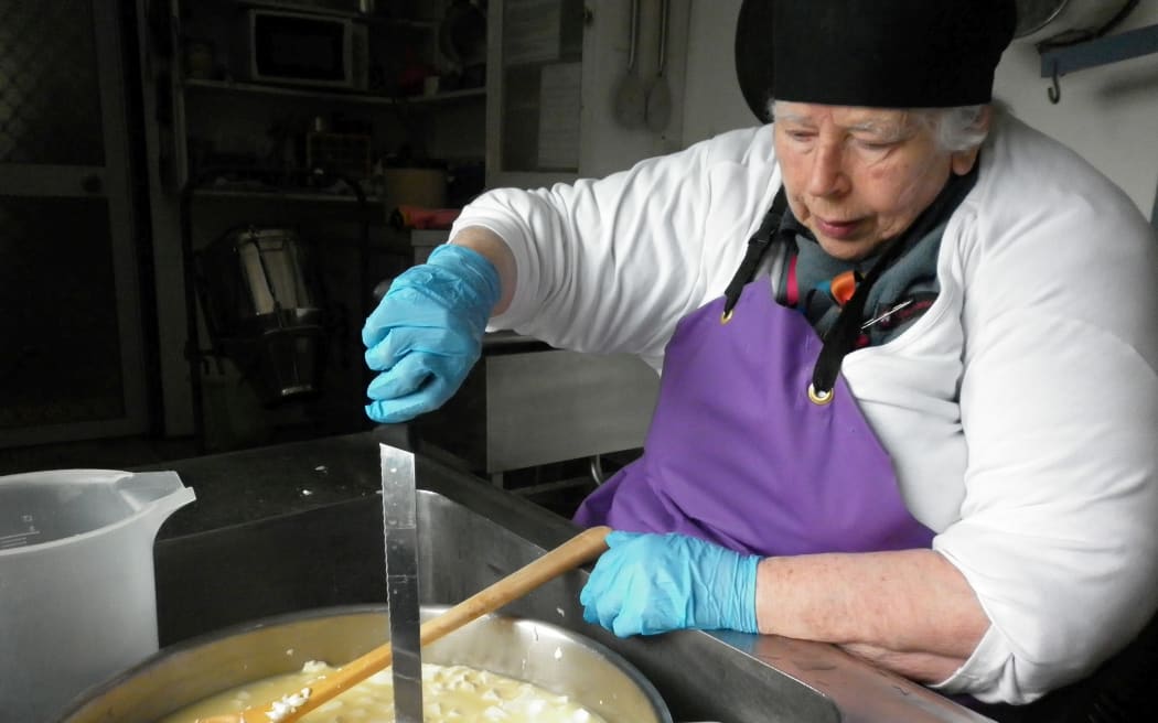 Biddy making cheese at her Eketahuna factory.