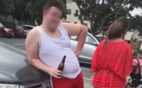 A screengrab from the video posted on social media of a woman challenging the tourists for littering at Takapuna Beach.