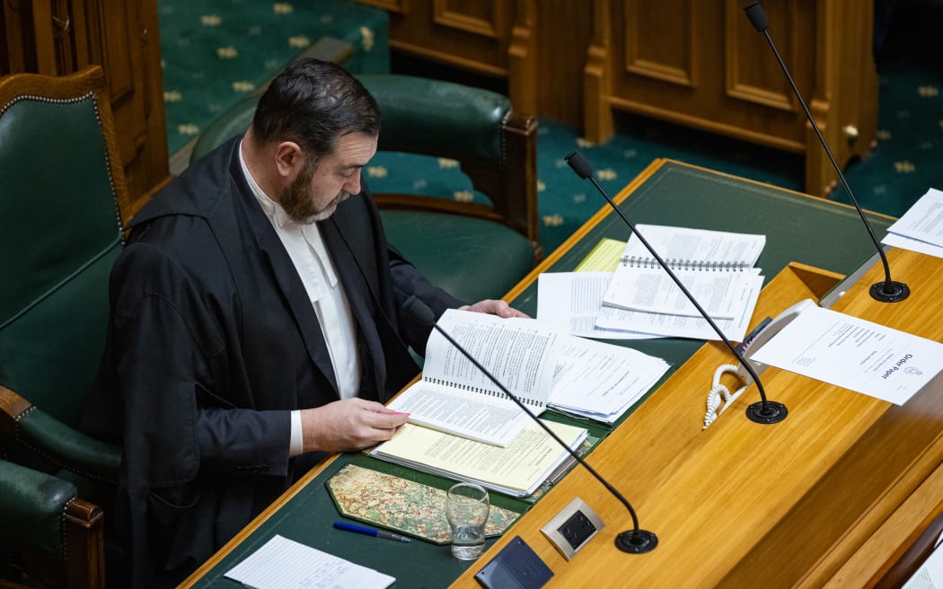 The Clerk of the House of Representatives, David Wilson, has a quick squiz at Parliament's rule book in case the Speaker needs his advice.