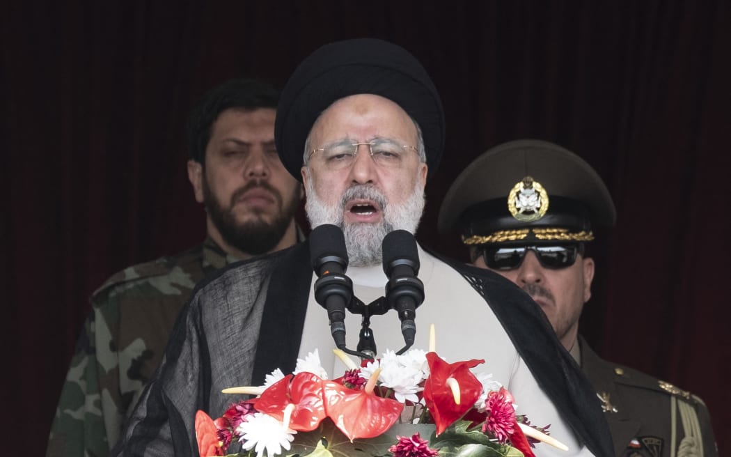 Iranian President Ebrahim Raisi (C) is addressing attendees at a military parade marking Iran's Army Day anniversary at an Army military base in Tehran, Iran, on April 17, 2024. (Photo by Morteza Nikoubazl/NurPhoto) (Photo by Morteza Nikoubazl / NurPhoto / NurPhoto via AFP)