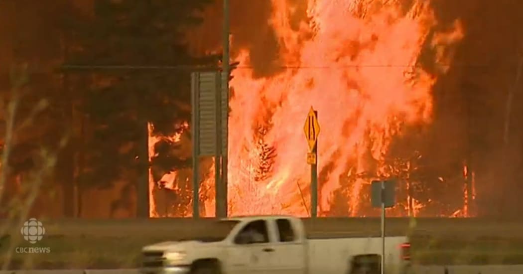 Thousands of people are fleeing Fort McMurray in Canada as a fire threatens the city.