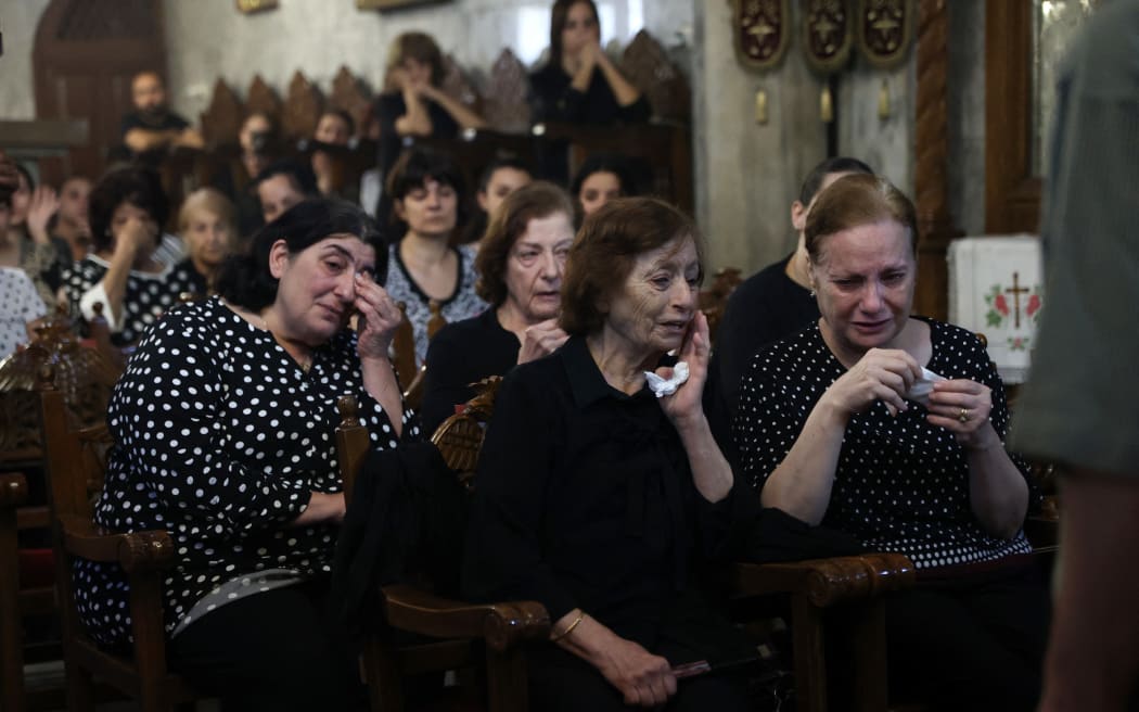 Christian Palestinians mourn Saad Salameh and Foumia Ayyad, killed earlier in an Israeli strike that hit the Holy Family Church in Gaza City, during their funeral ceremony at the Saint Porphyrius Church on July 17, 2025. An Israeli strike on Gaza's only Catholic church killed three people on July 17, the Latin Patriarchate of Jerusalem said, as Israel said it "never targets" religious sites and regretted any harm to civilians. (Photo by Omar AL-QATTAA / AFP)