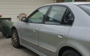 A car with a cracked windscreen at the scene of a shooting on Naylors Drive in Mangere.