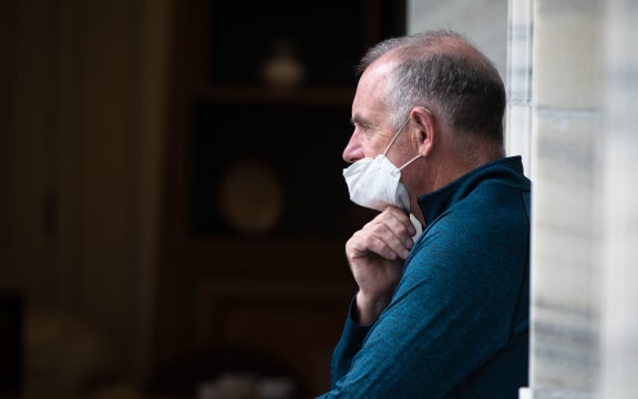 Speaker of the House Trevor Mallard looks at the protest from the Parliament balcony.