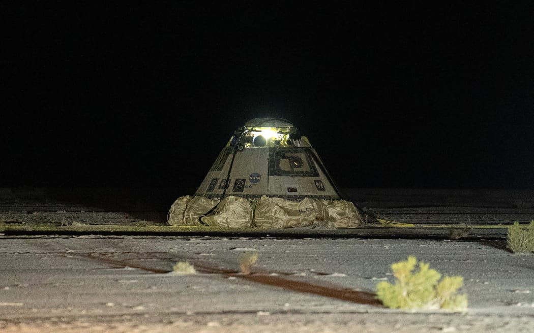 This video grab courtesy of Boeing taken on September 7, 2024 shows Boeing's Starliner landed at White Sands Space Harbor in White Sands, New Mexico. Boeing's beleaguered Starliner returned to Earth empty September 7, 2024 after NASA deemed it too risky to bring home the astronauts who rode the spaceship up to the International Space Station. (Photo by BOEING / AFP) / RESTRICTED TO EDITORIAL USE - MANDATORY CREDIT "AFP PHOTO / BOEING" - NO MARKETING NO ADVERTISING CAMPAIGNS - DISTRIBUTED AS A SERVICE TO CLIENTS