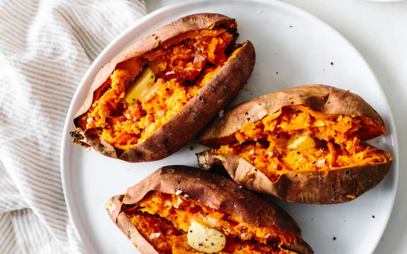 Roasted kumara on a white plate