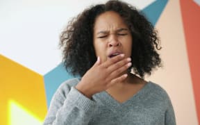 Tired woman yawning