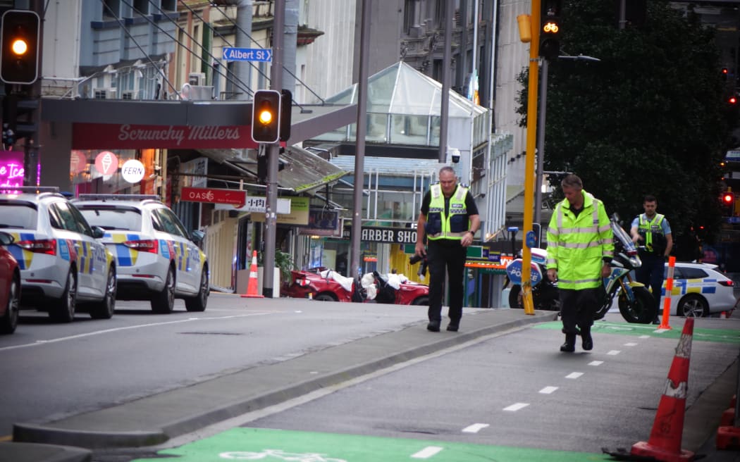 The scene of a crash on Auckland's Victoria Street involving a car and police.