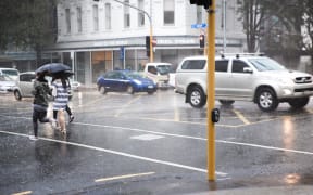 Rain pours down in the Auckland CBD.