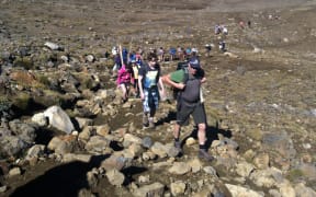 Crowds of people walk the Tongariro Crossing