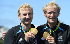 Hamish Bond, left, and Eric Murray celebrate with their gold medals on the podium after wining the Men's Pair Final of the Rowing events of the Rio 2016 Olympic Games at Lagoa Stadium in Rio de Janeiro, Brazil, 11 August 2016.