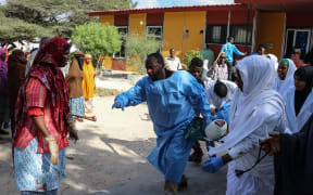 A massive car bomb exploded in a busy area of Mogadishu, leaving at least 76 people dead.