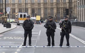 Police cordon off the area near Parliament in London where an assailant attacked a police officer and pedestrians.