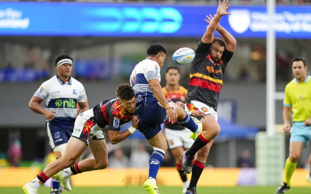 Kyren Taumoefolau tackles Stephen Perofeta during the Blues v Chiefs, Super Rugby Pacific match, Eden Park.