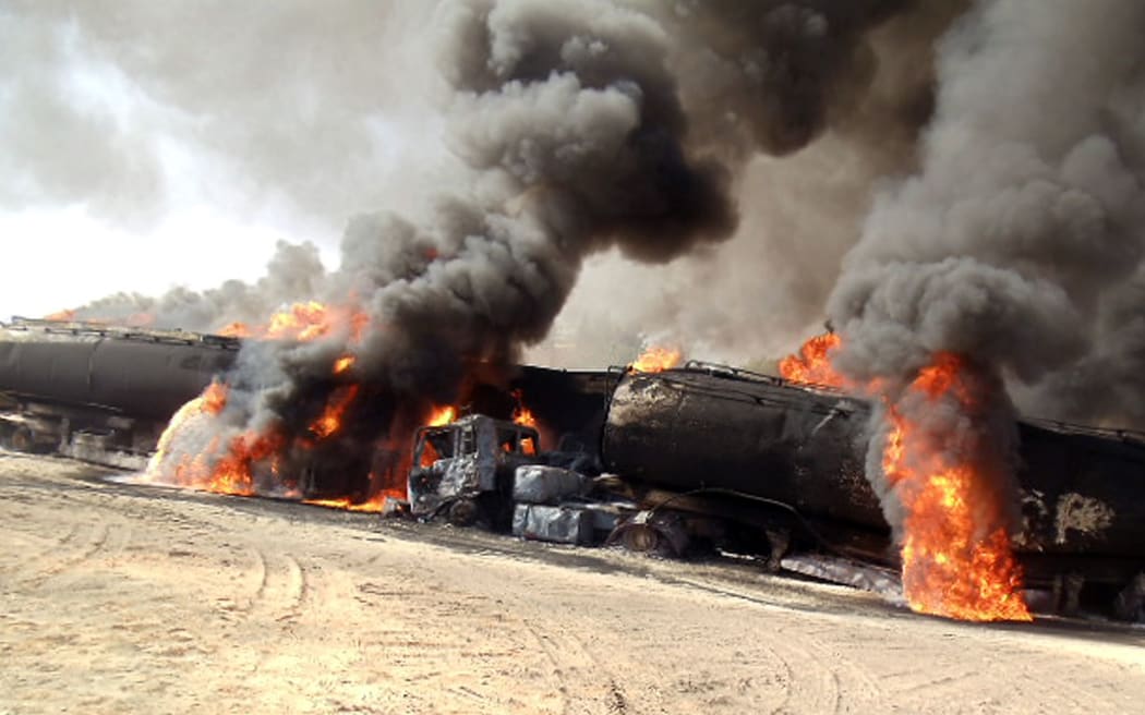 Road tankers burn in an earlier Taliban attack.