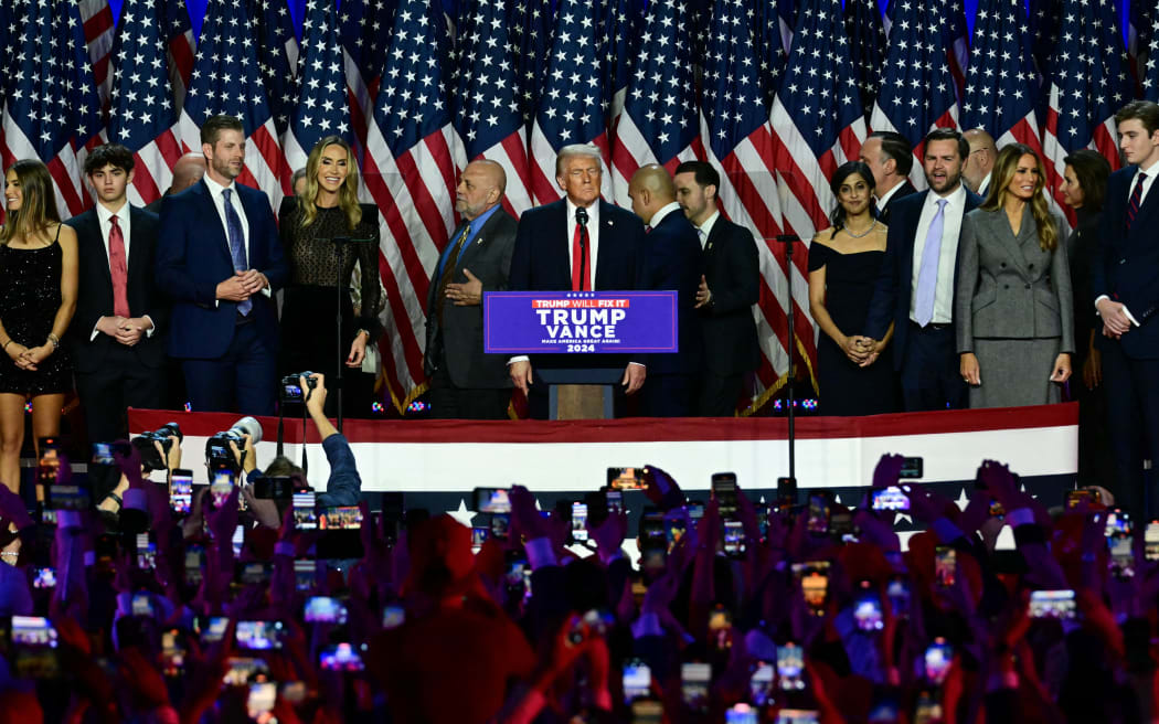 Former US President and Republican presidential candidate Donald Trump and US Senator from Ohio and Republican vice presidential candidate J.D. Vance and their families appear on stage at the West Palm Beach Convention Center in Florida.