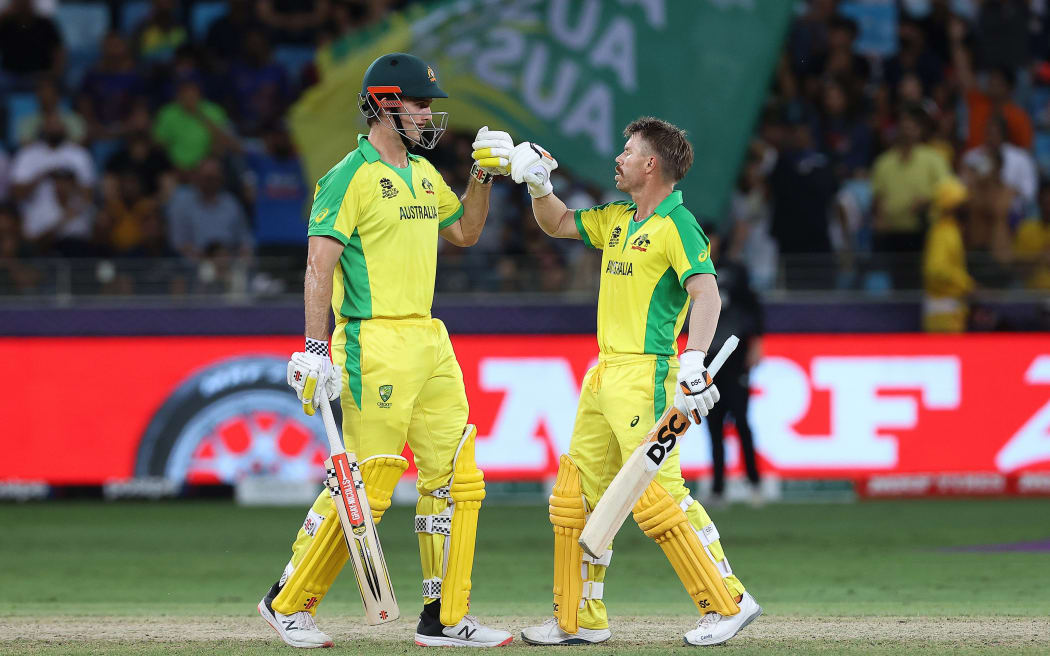 Mitchell Marsh (left) reacts with David Warner of Australia react during the ICC Men's T20 World Cup final cricket match between Australia and New Zealand at Dubai International Cricket Stadium in Dubai, United Arab Emirates, Sunday, November 14, 2021.