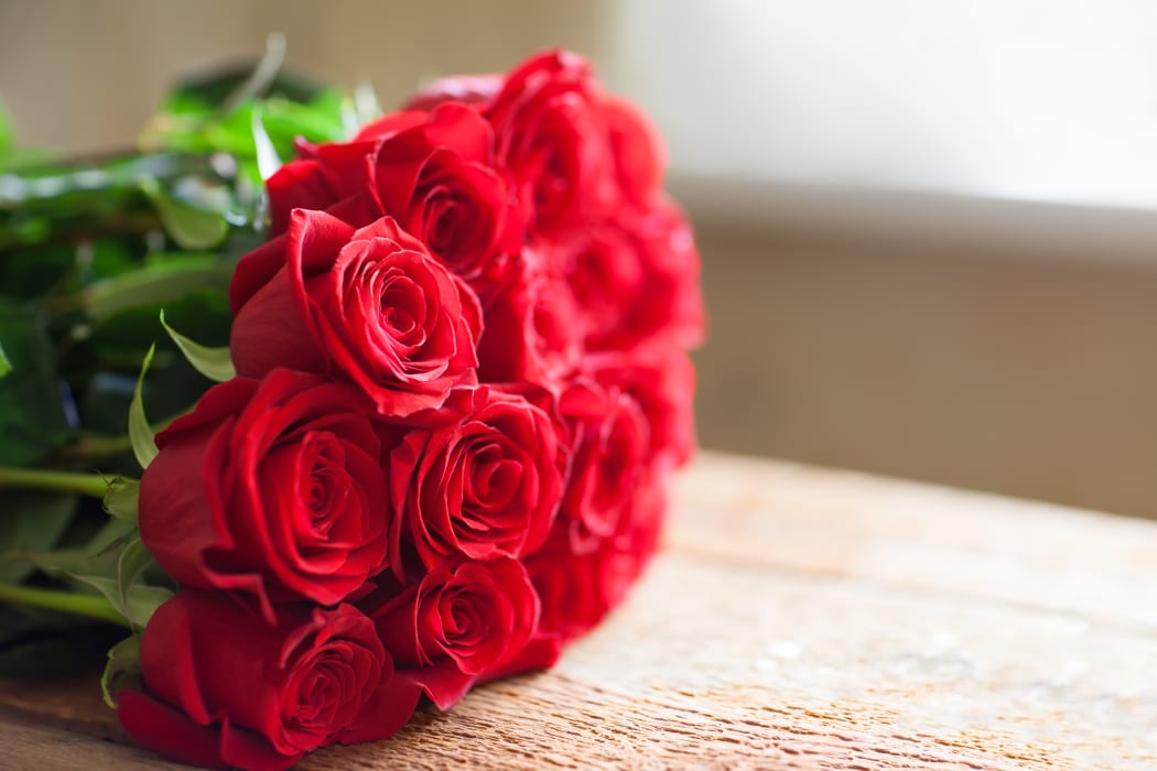 Red roses bouquet. Flowers. Romantic background