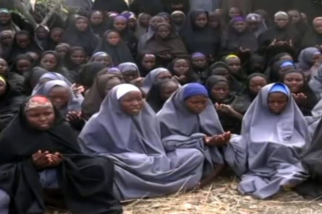 A screengrab from the Boko Haram video of shows girls, wearing the full-length hijab and praying in a rural location.