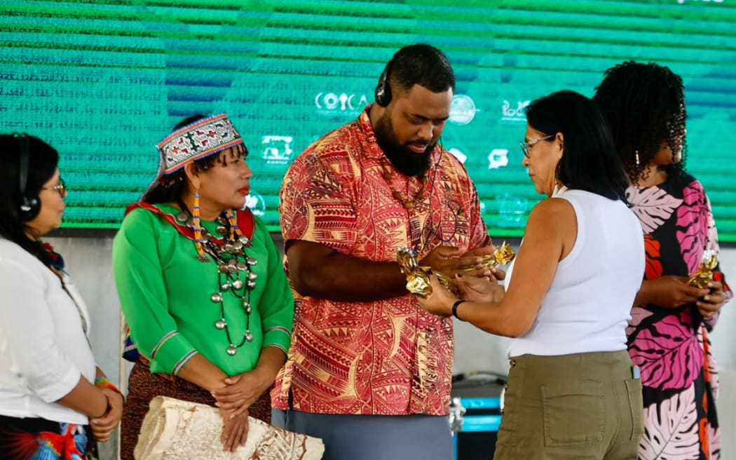 350.org's Fiji community organiser George Nacewa, centre, says it is now up to the Brazil COP Presidency too act.