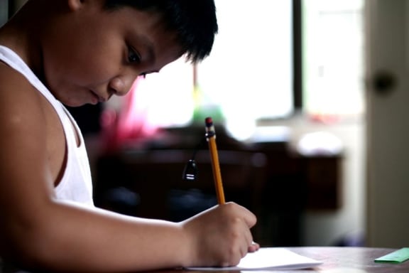 Child writing (file photograph).