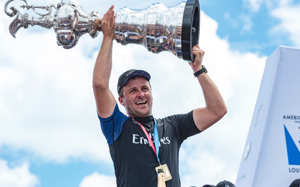 Cyclor Simon Van Velthooven holds up the America's Cup after Team New Zealand's victory in Bermuda in 2017, 26 June 2017.  
Copyright photo: Chris Cameron / www.photosport.nz