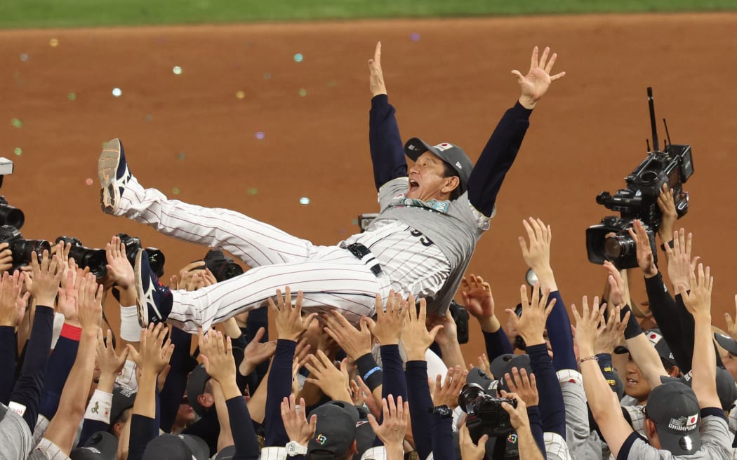 Hideki Kuriyama, a manager of the Japan National Team is lifted in the air after Japan defeated the U.S.A. in the 2023 World Baseball Classic final.