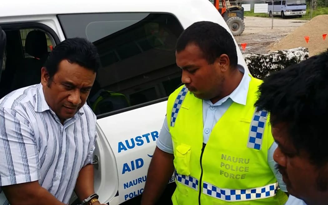Mathew Batsiua being escorted into court