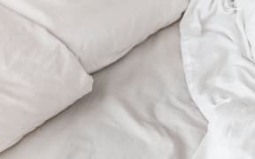 White sheets and pillows on a bed