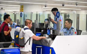 Inbound passengers go through border inspection procedures at Haikou Meilan International Airport in Haikou, south China's Hainan Province, in October 2025.
