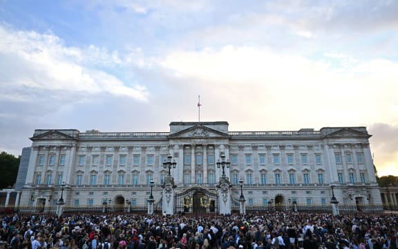 The Union flag flies half mast as people gather to mark the death of Queen Elizabeth II at Buckingham Palace on September 9, 2022 in London, England.