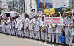 School girls hold placards during a silent protest rally against the recent rape cases of two teenage girls in the Chatra and Pakur districts of Jharkhand, in Ranchi on May 8, 2018.