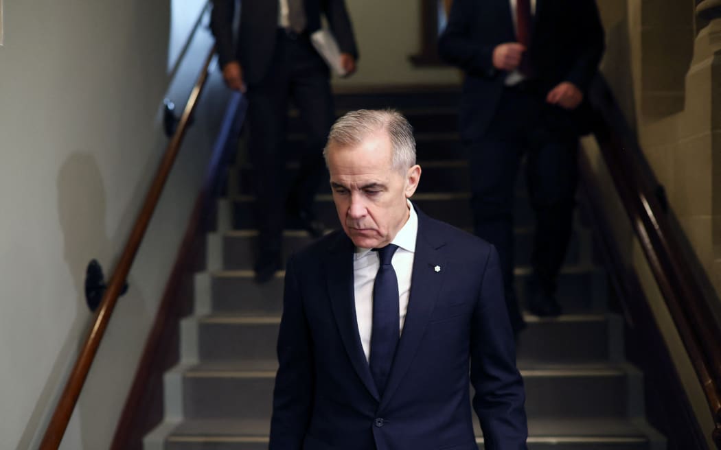Canada's Prime Minister Mark Carney makes his way to the National Caucus meeting on Parliament Hill February 11, 2026 in Ottawa, Canada. (Photo by Dave Chan / AFP)