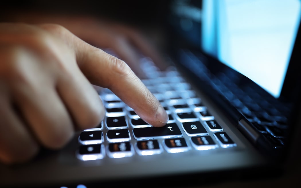 Late night internet addiction or working late man using laptop computer in the dark