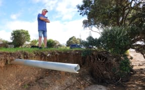 Long-time Paihia resident Ross Robertson inspects the disappearing Waitangi waterfront.