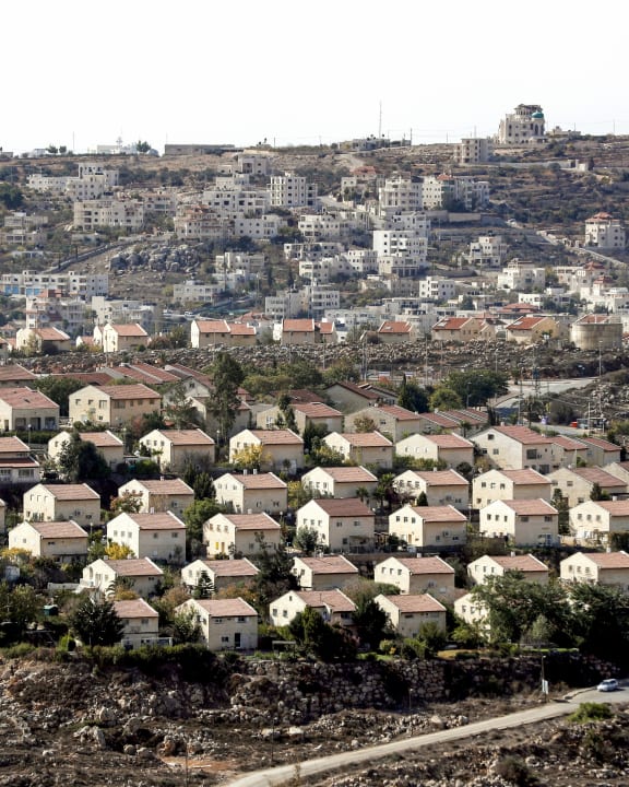 Houses in the settlement of Ofra in the Israeli-occupied West Bank, established in the vicinity of the Palestinian village of Baytin (background).