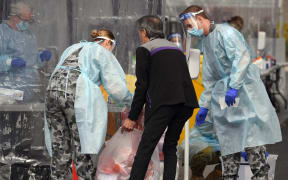 Members of the Australian Defence Force package swab samples ready for testing at a drive-through COVID-19 coronavirus testing station in the Melbourne suburb of Fawkner on July 2, 2020.