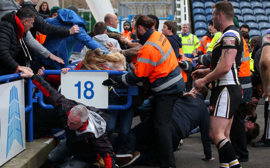 Salford players scuffle with their own fans.