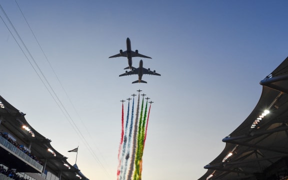 UAE elite aerobatic flying team "Al Fursan" escorts an Etihad A380 and a Boeing 787-9 Dreamliner aircraft as they fly over the Yas Marina Circuit in Abu Dhabi, ahead of the final race of the Formula One Grand Prix season, 2019