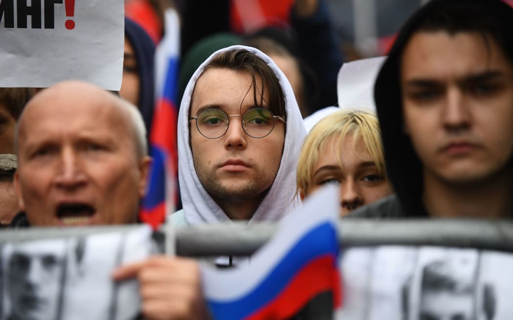 People attend a rally in support of the registration of independent candidates for the September's elections to the Moscow City Duma and against police brutality, in Moscow, Russia.