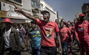 Supporters of the opposition party Movement for Democratic Change (MDC), protest against alleged widespread fraud by the election authority and ruling party, after the announcement of election's results, in the streets of Harare.
