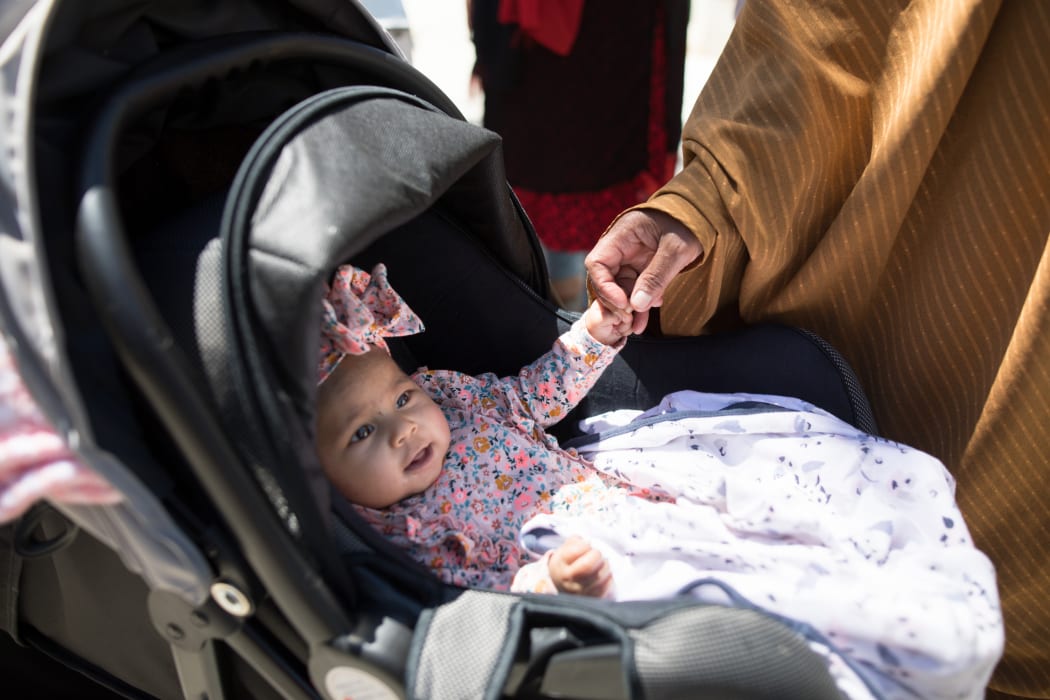 Muhubo plays with baby Noor at the Sisters and Children event.