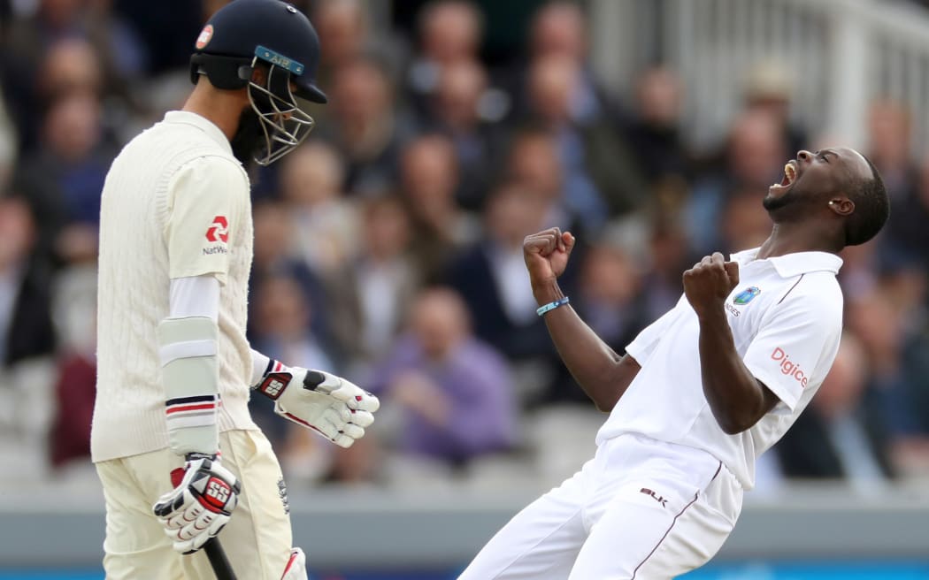 The West Indies' Kemar Roach celebrates dismissing England batsman Moeen Ali.