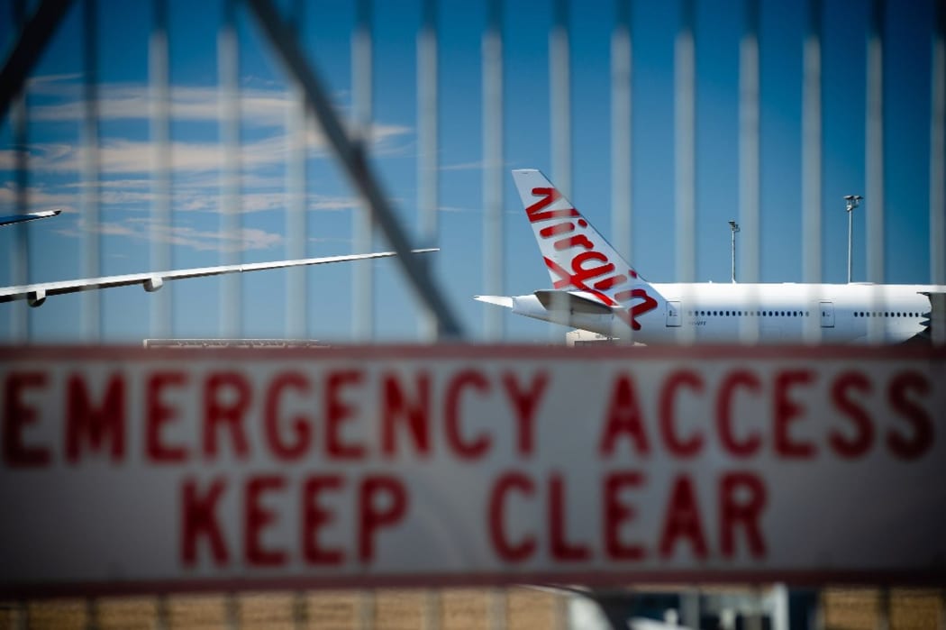 Virgin Australia aircraft are seen parked on the tarmac at Brisbane International airport on April 21, 2020.