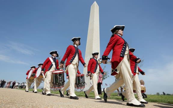 Members of the US Army Old Guard Fife and Drum Corps march parade in front of the Washington Monument on Monday.
