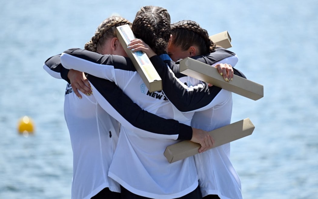 New Zealand's gold medallists Lisa Carrington, Alicia Hoskin, Olivia Brett and Tara Vaughan celebrate on the podium during the medal ceremony after the women's kayak four 500m final of the canoe sprint competition at Vaires-sur-Marne Nautical Stadium in Vaires-sur-Marne during the Paris 2024 Olympic Games on August 8, 2024. (Photo by Bertrand GUAY / AFP)