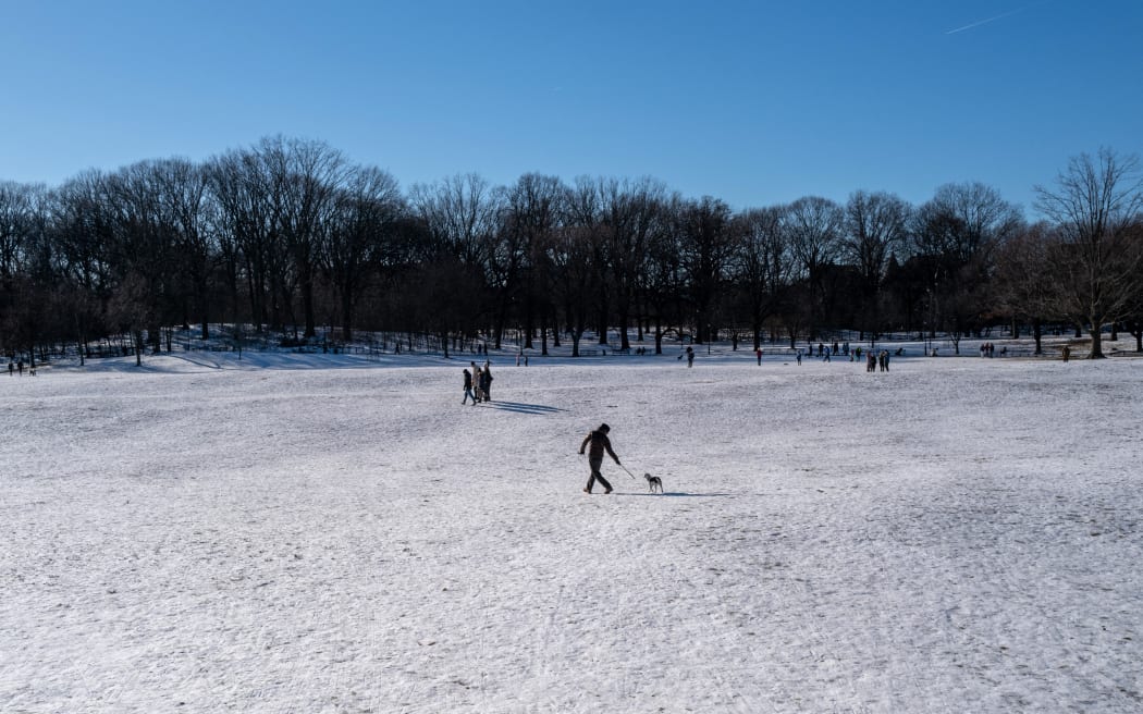 NEW YORK, NEW YORK - JANUARY 21: People walk through the snow in Brooklyn's Prospect Park on a cold winter afternoon on January 21, 2024 in New York City. New York City received around 3 inches of snow over the last week, breaking a 700-day streak without measurable snow.   Spencer Platt/Getty Images/AFP (Photo by SPENCER PLATT / GETTY IMAGES NORTH AMERICA / Getty Images via AFP)