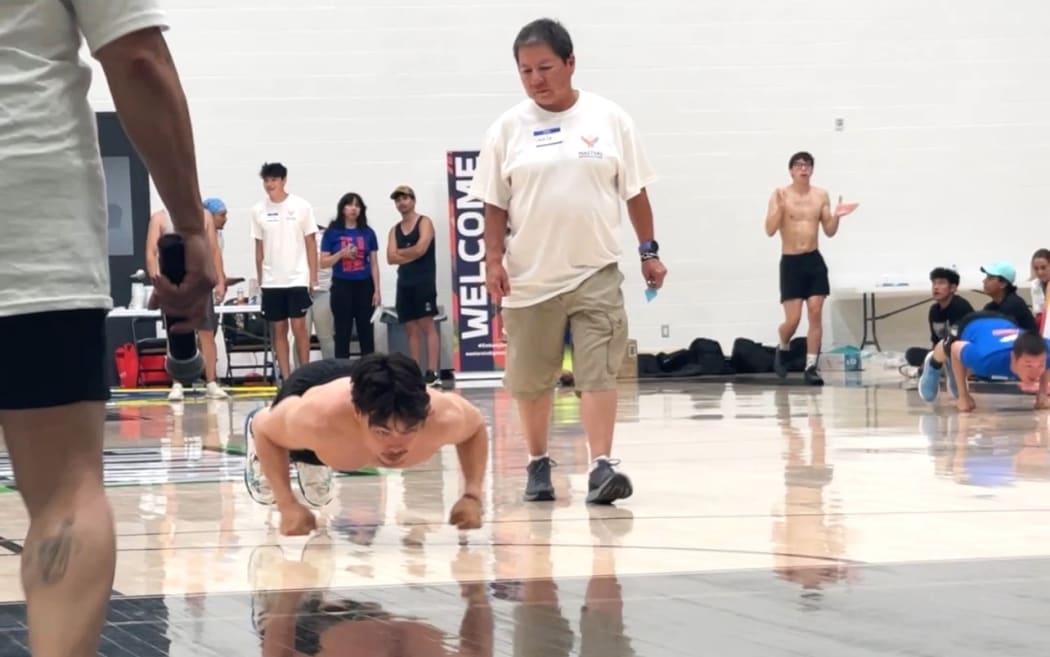 A competitor feels the strain in the seal hop, also known as the knuckle hop.