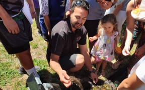 William Anaru, Te Arawa Lakes Trust, holding catfish