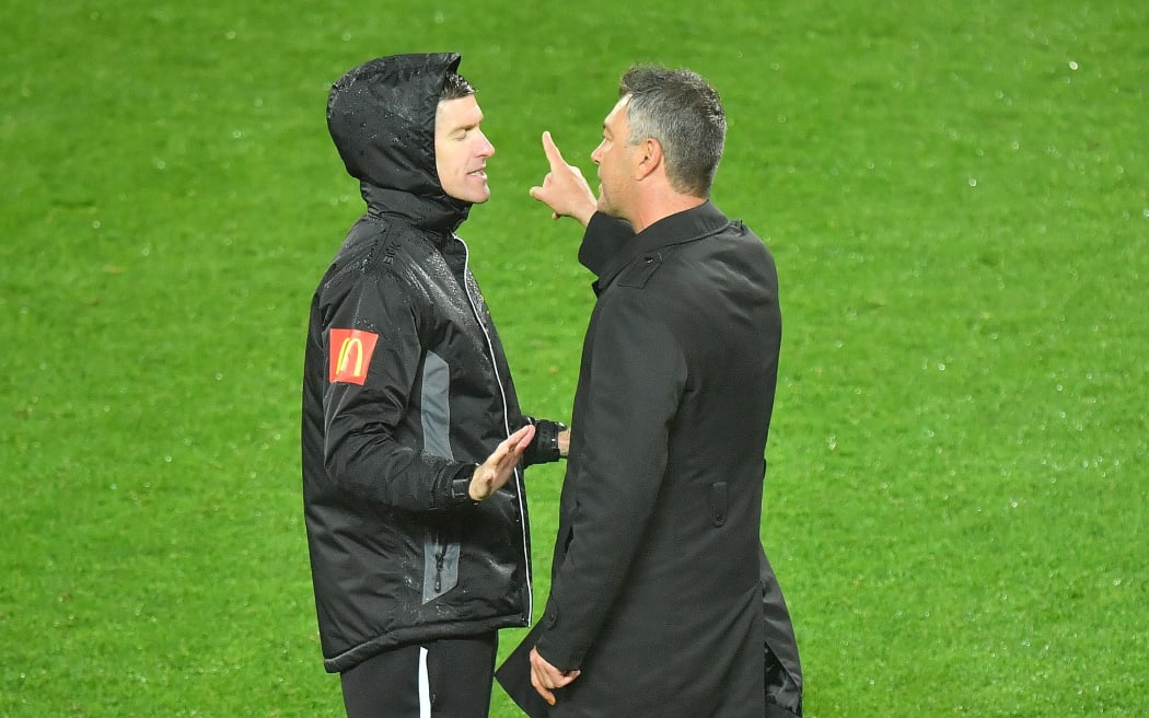 Phoenix coach Mark Rudan talks to a match official.